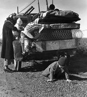 Missouri migrant family stalled on US highway 99 near Tracy, California. February 1937